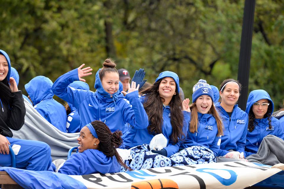 women's basketball team riding on a homecoming float